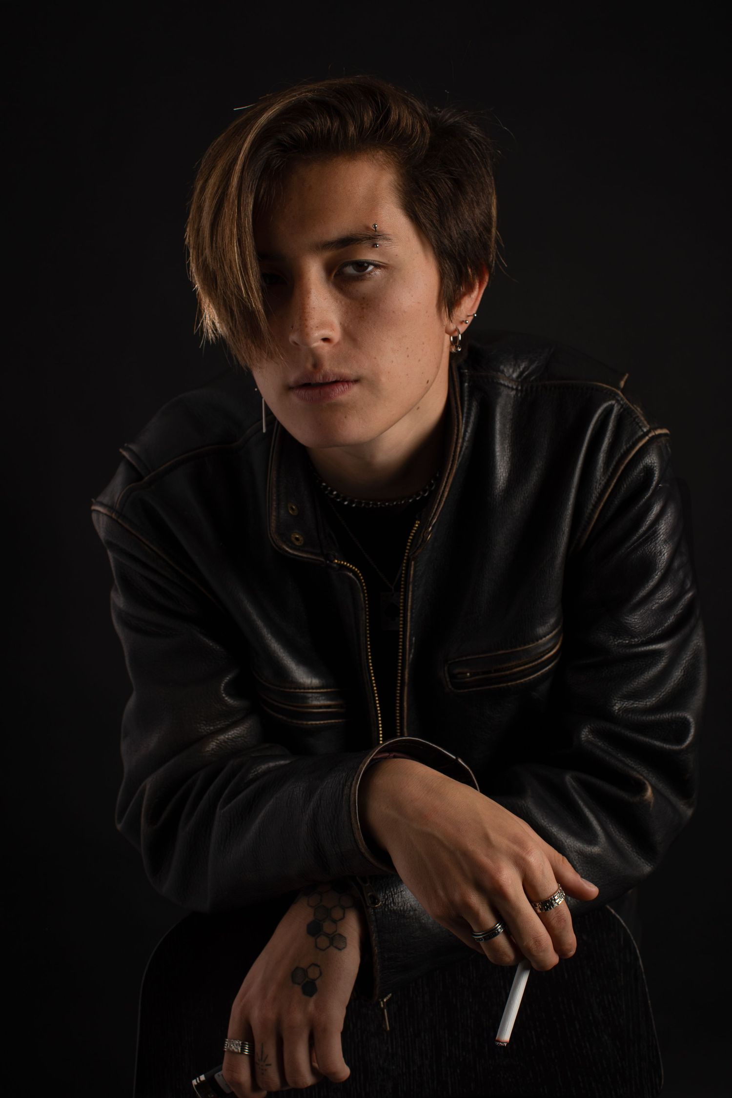 Artistic dark portraits in leather jacket creating dramatic shadows and mood.
