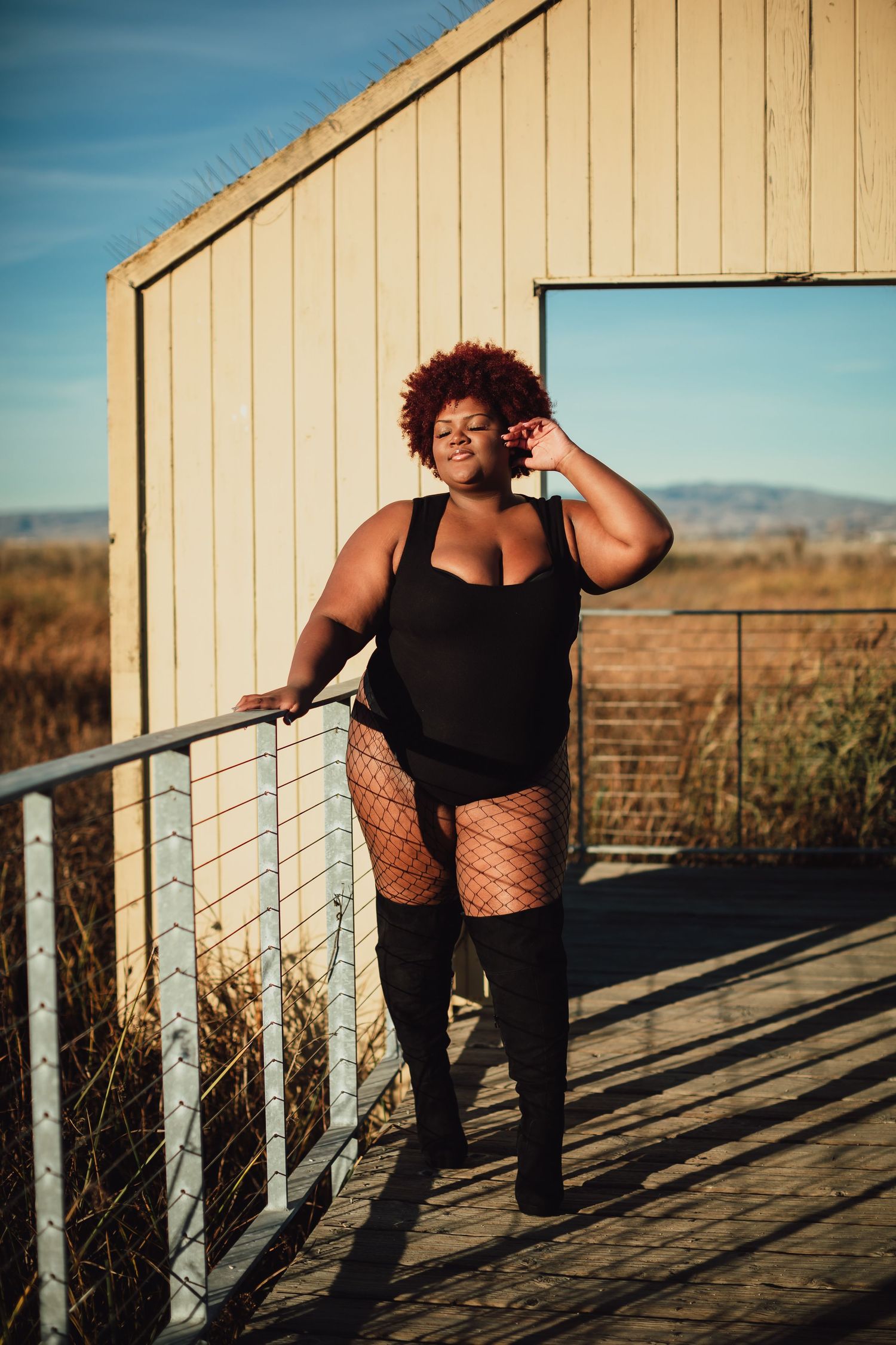 Expressive poses photographed on a deck with mountains visible in the background.
