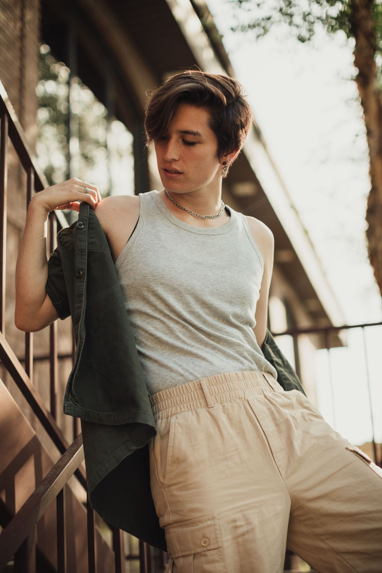 Casual fashion poses on outdoor steps with natural lighting.