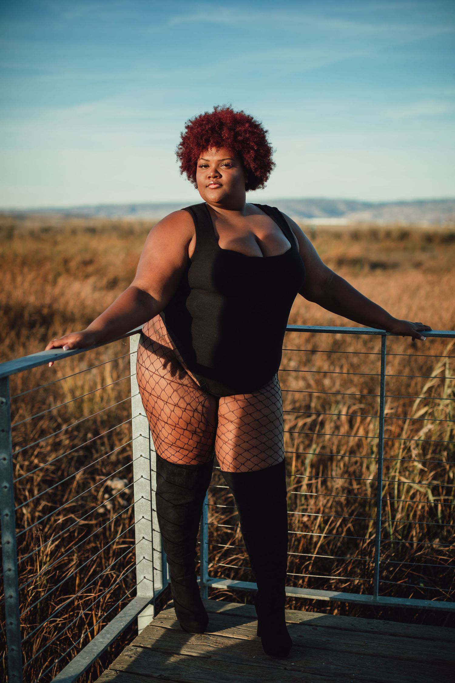 Fashion portrait series on wooden deck with mountains in background.