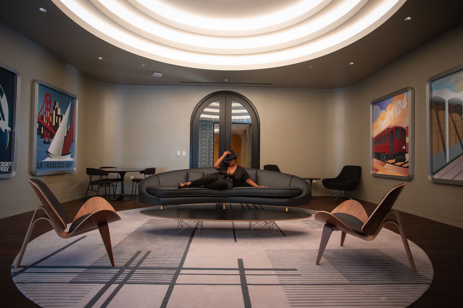 Modern room interior with circular ceiling light and contemporary furniture arrangement.
