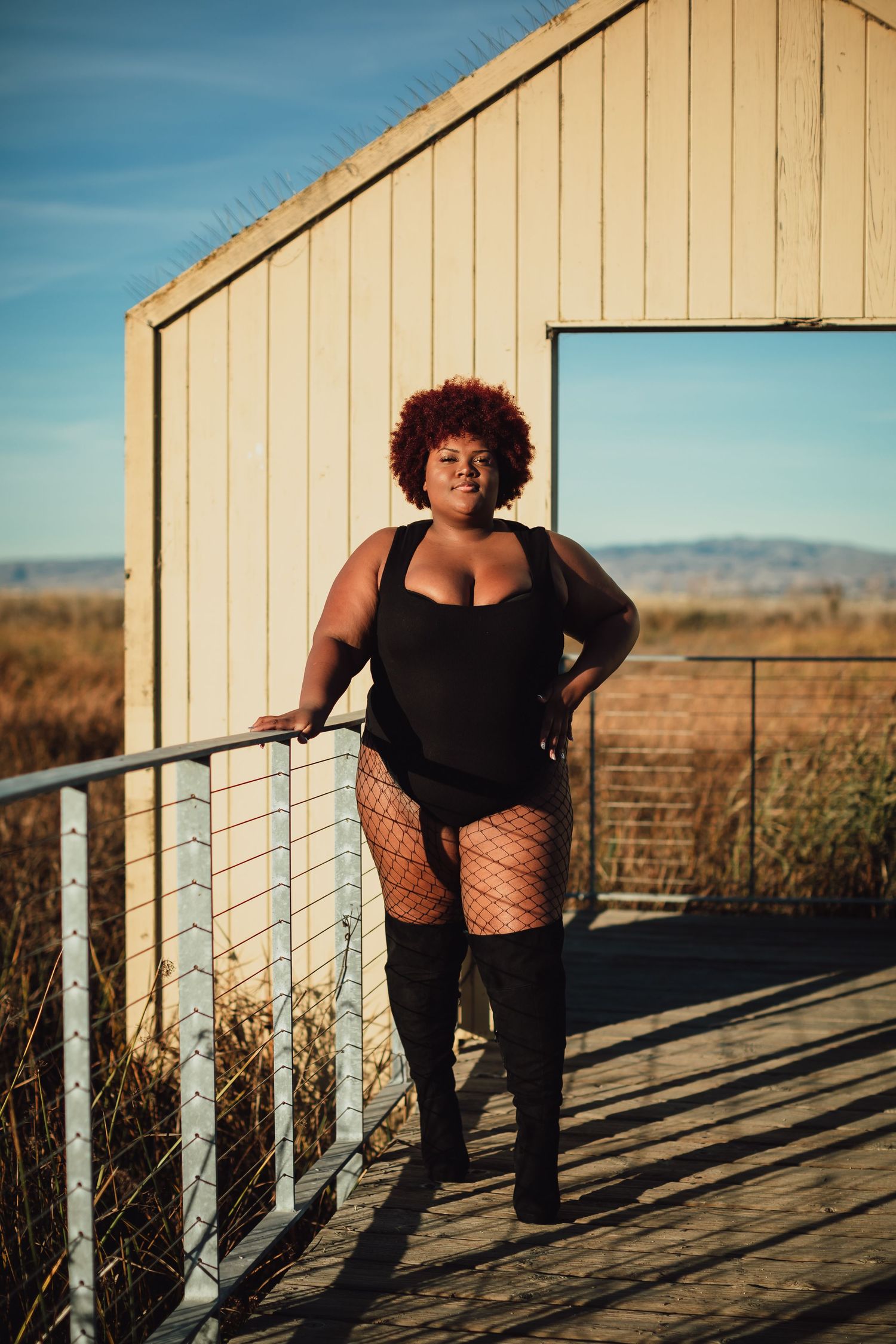 Dramatic poses photographed at sunset on a rustic wooden deck with mountain views.