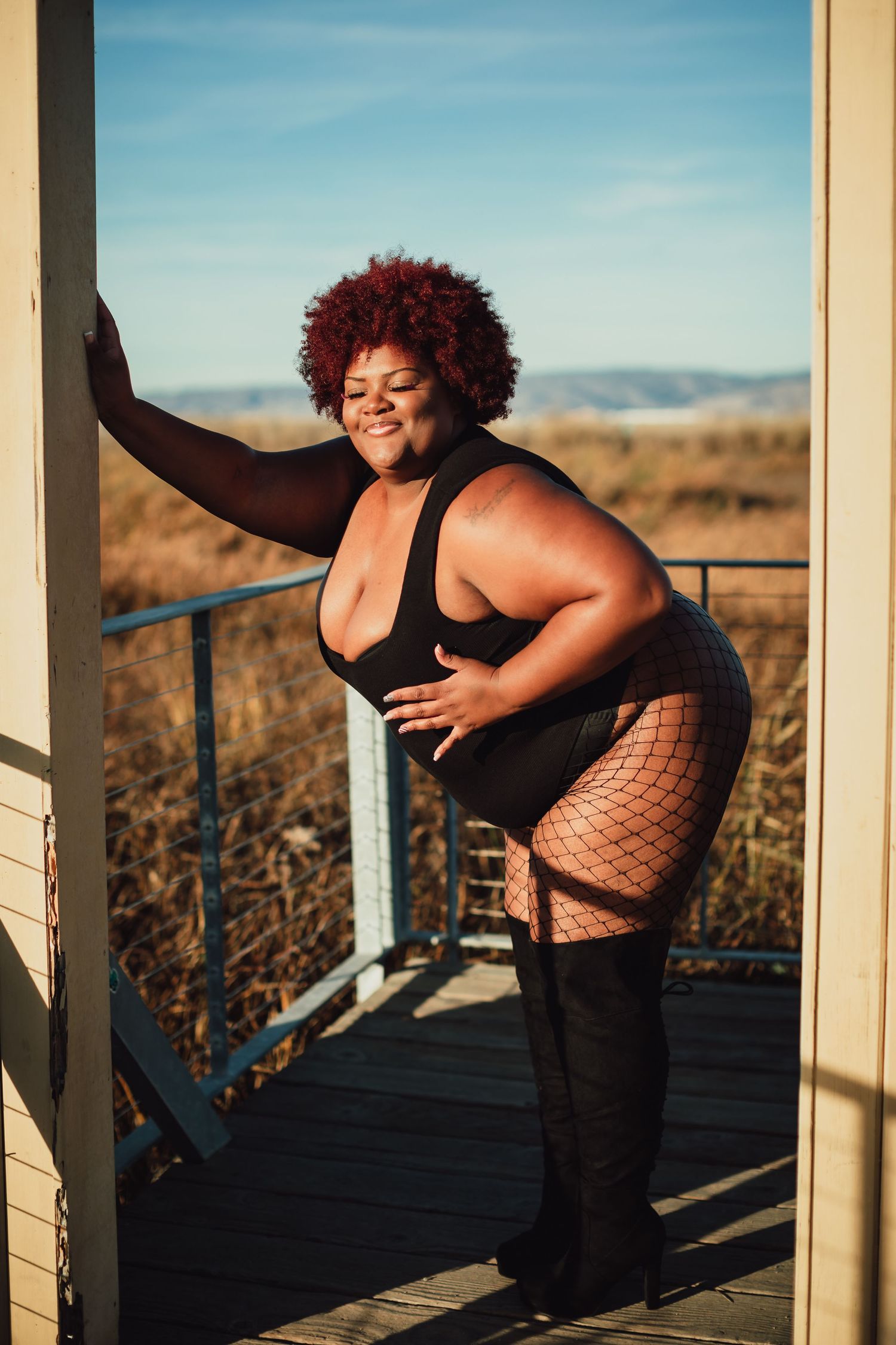 Energetic dance movements photographed in warm sunlight on an outdoor deck.