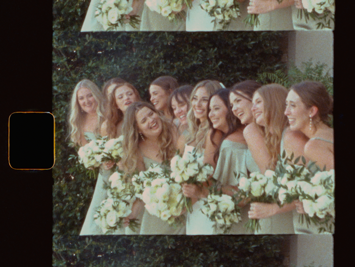Bridesmaids in mint green dresses laughing and holding white floral bouquets outdoors at a wedding.