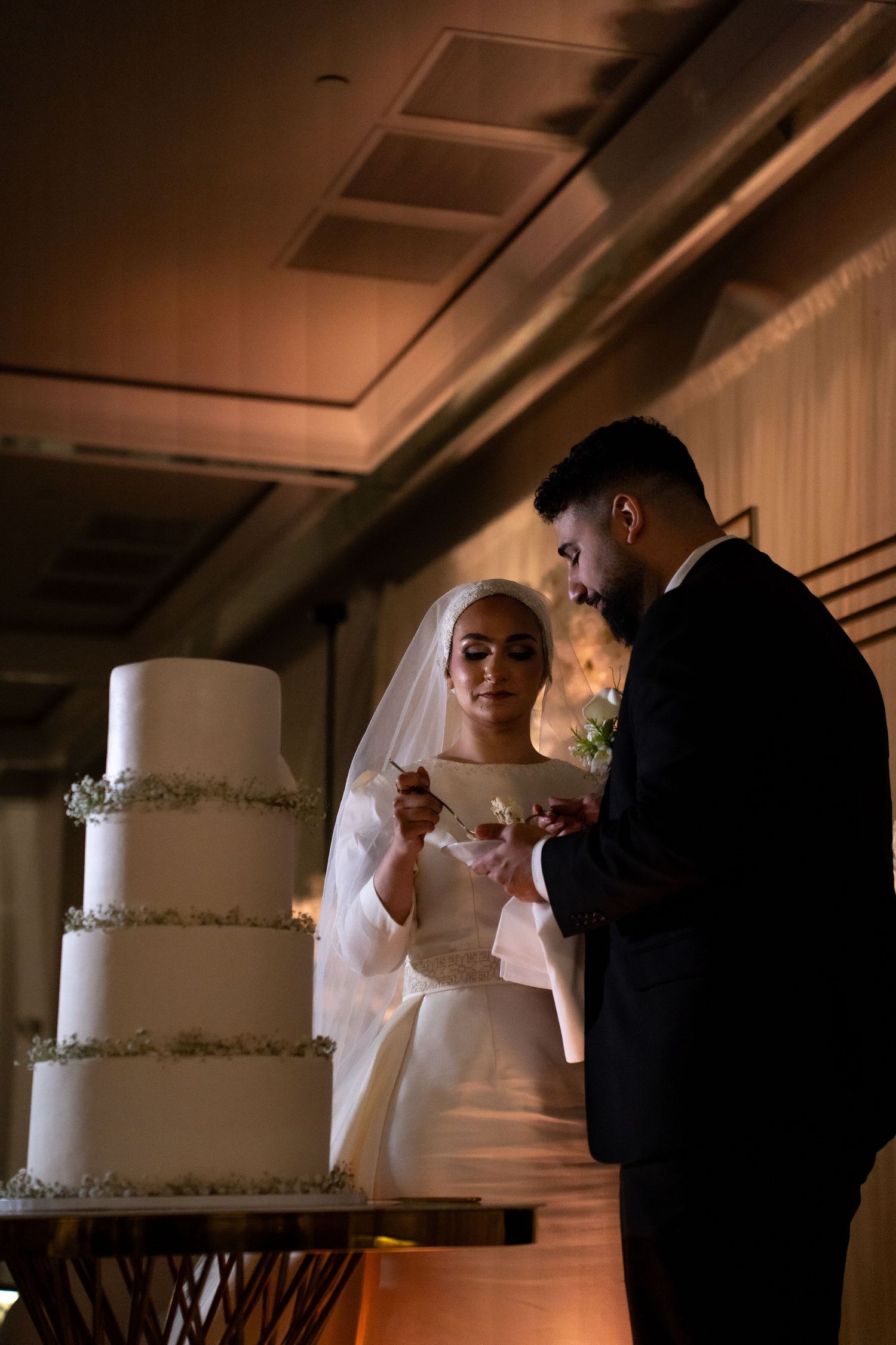 Elegant white tiered wedding cake with delicate silver details.