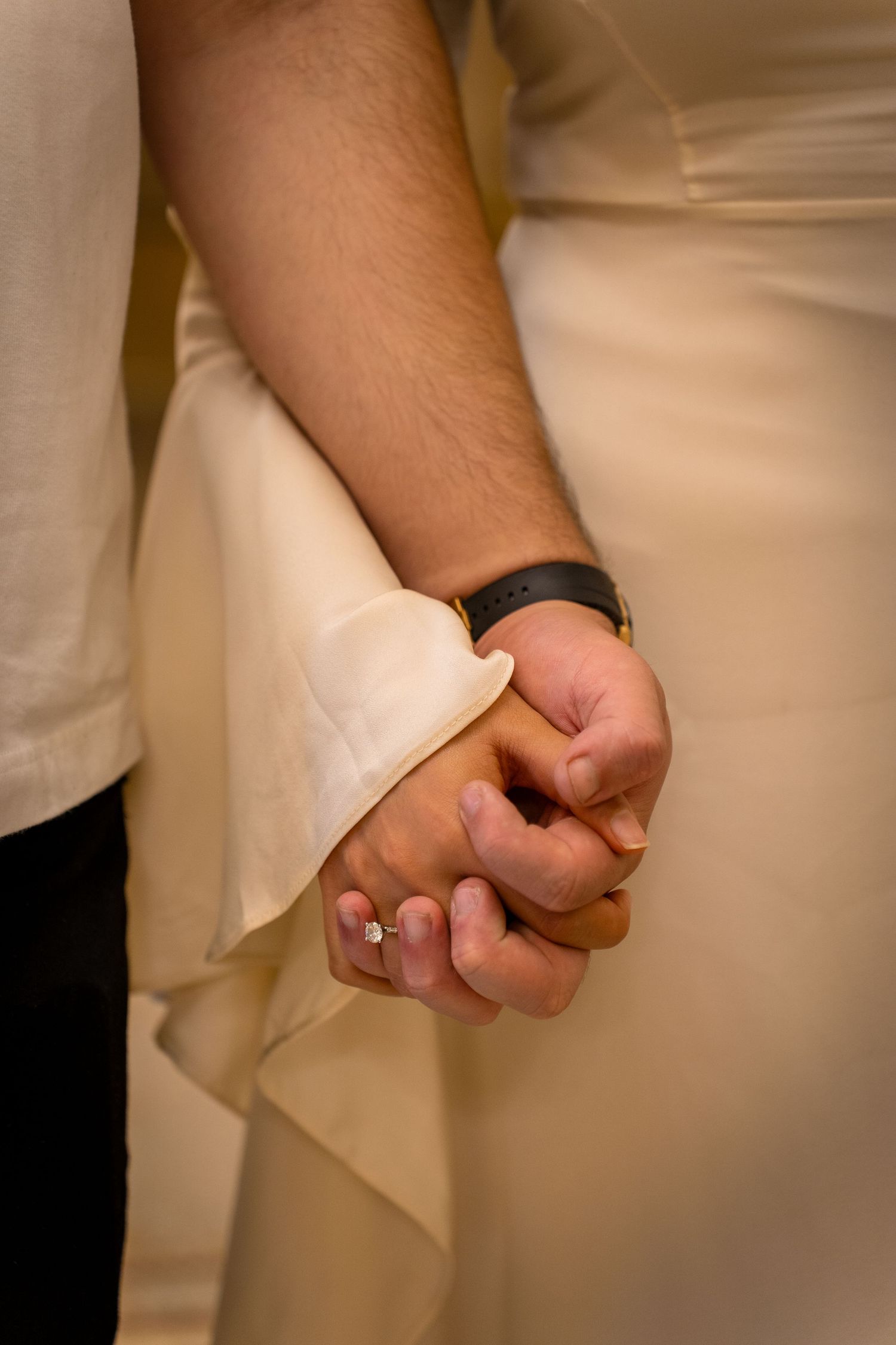 Close-up sequence showing hands folding a white napkin in elegant restaurant table setting style.
