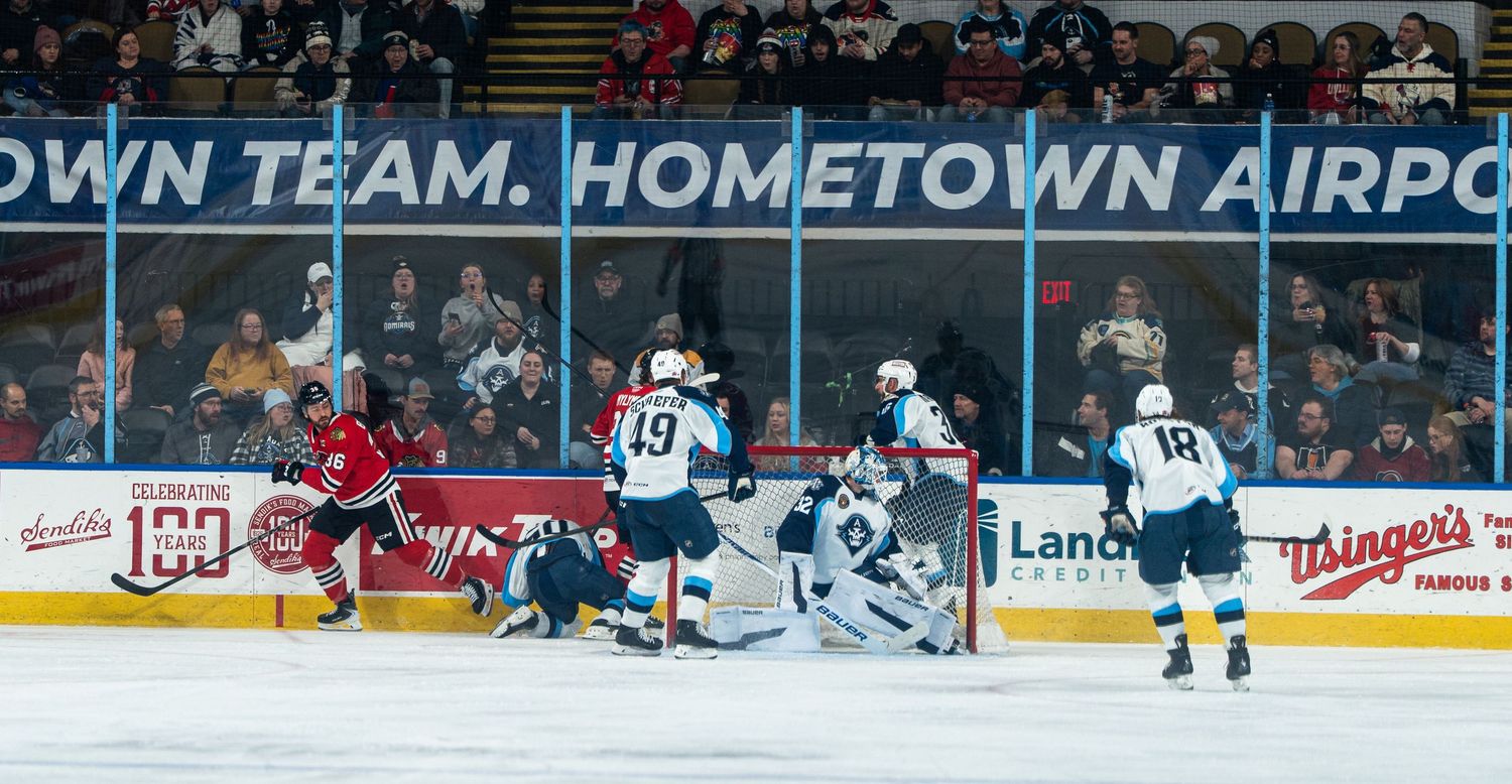 Hockey arena with 'Hometown Team' banner visible during gameplay.