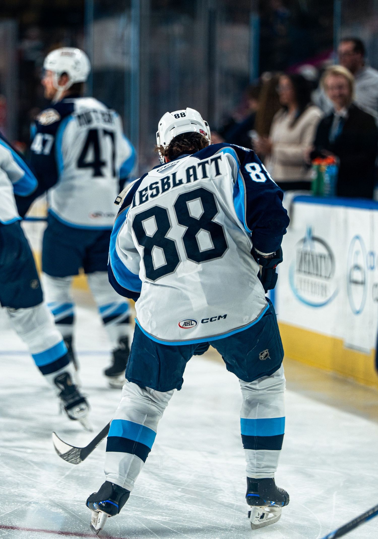 Hockey player wearing jersey number 88 skates on ice during a professional game.