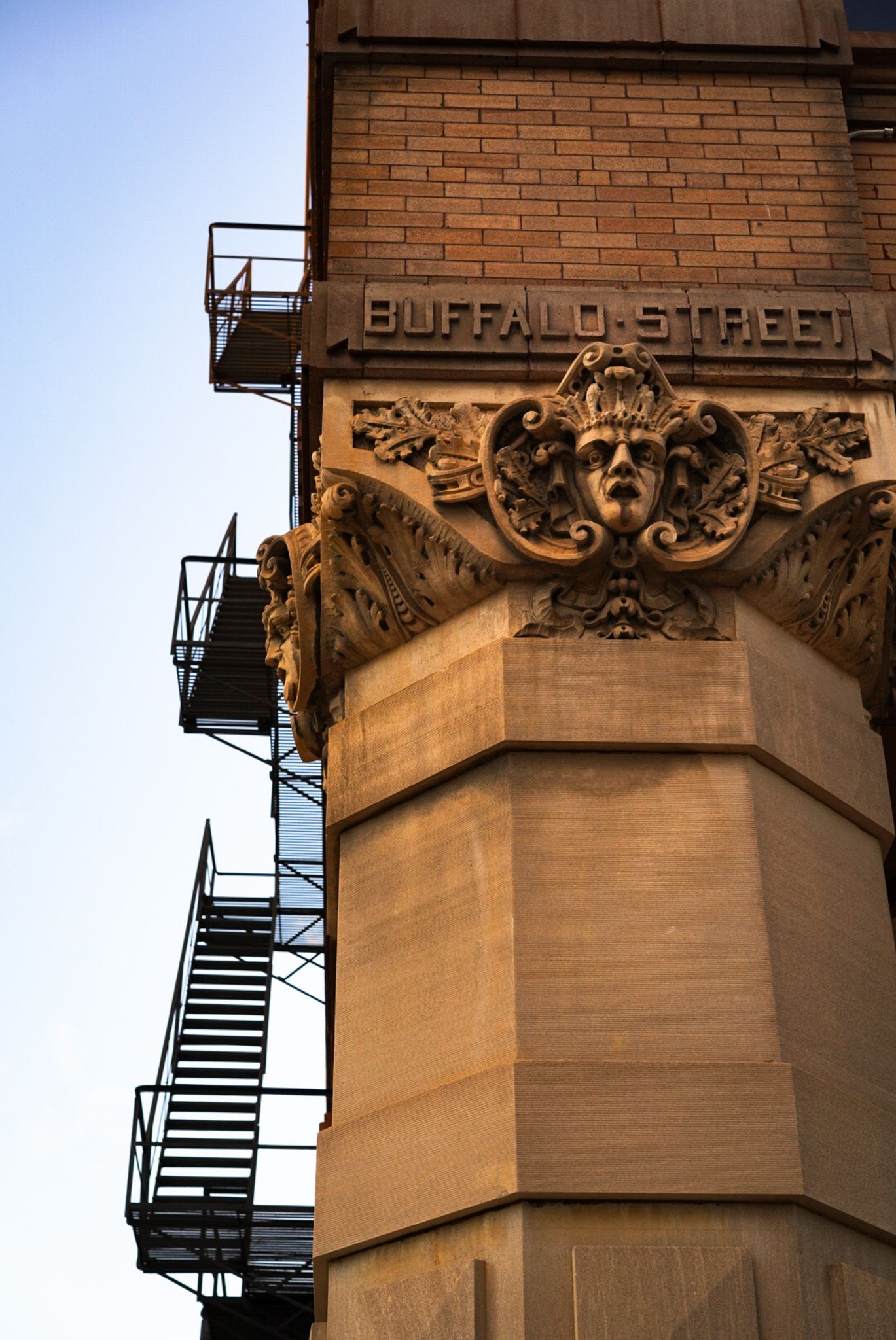 Ornate architectural detail of Buffalo Street building with decorative stone carvings.