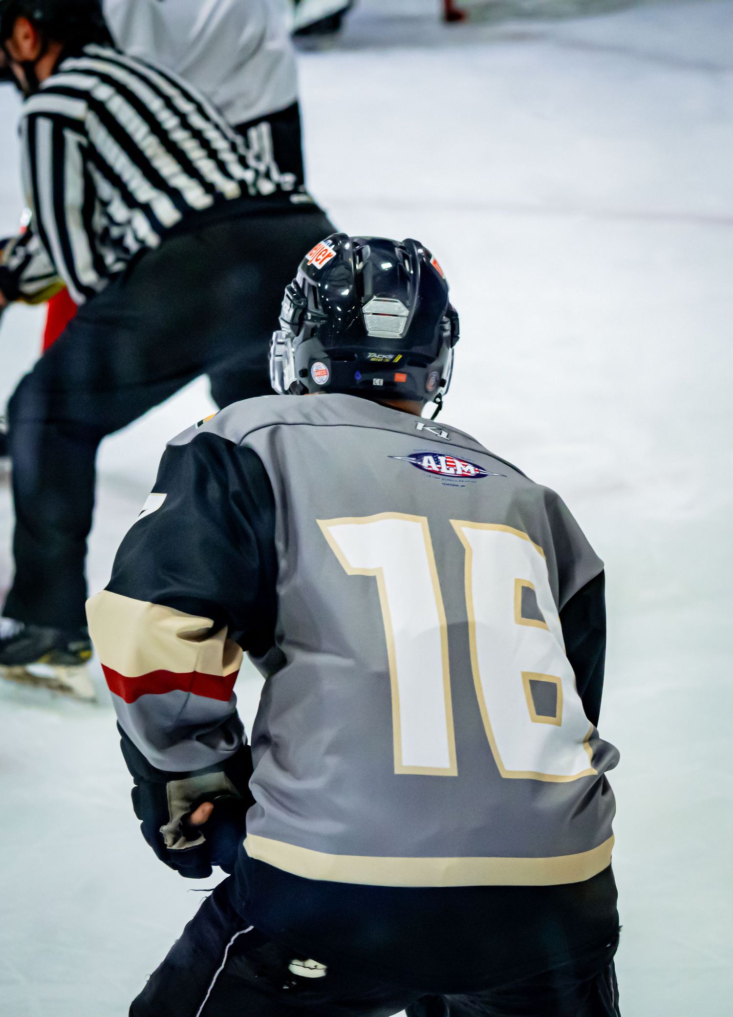Close-up of hockey player wearing jersey number 10 during game.