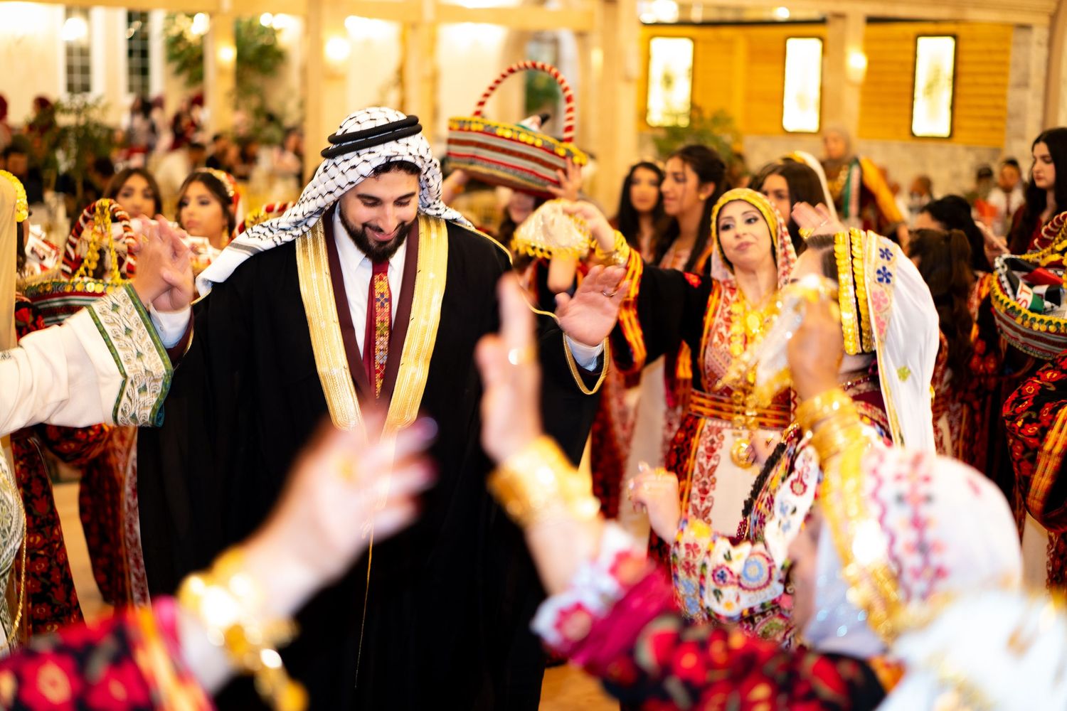 A festive celebration with traditional Middle Eastern decorations and dancing in a warmly lit venue.