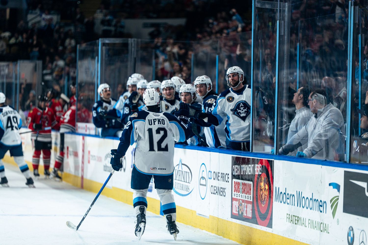 Wide view of a professional hockey game showing players spread across the ice during gameplay.