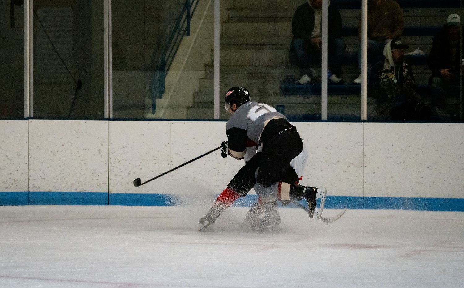 Hockey players in action on ice rink during competitive match.