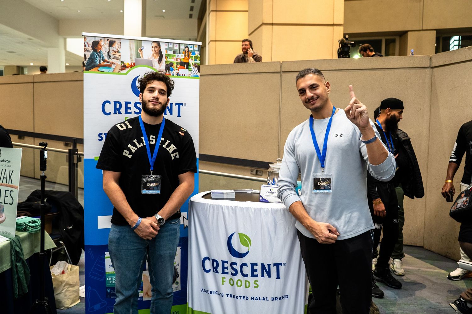 Conference attendees network and interact at a business event with Crescent company branding visible.