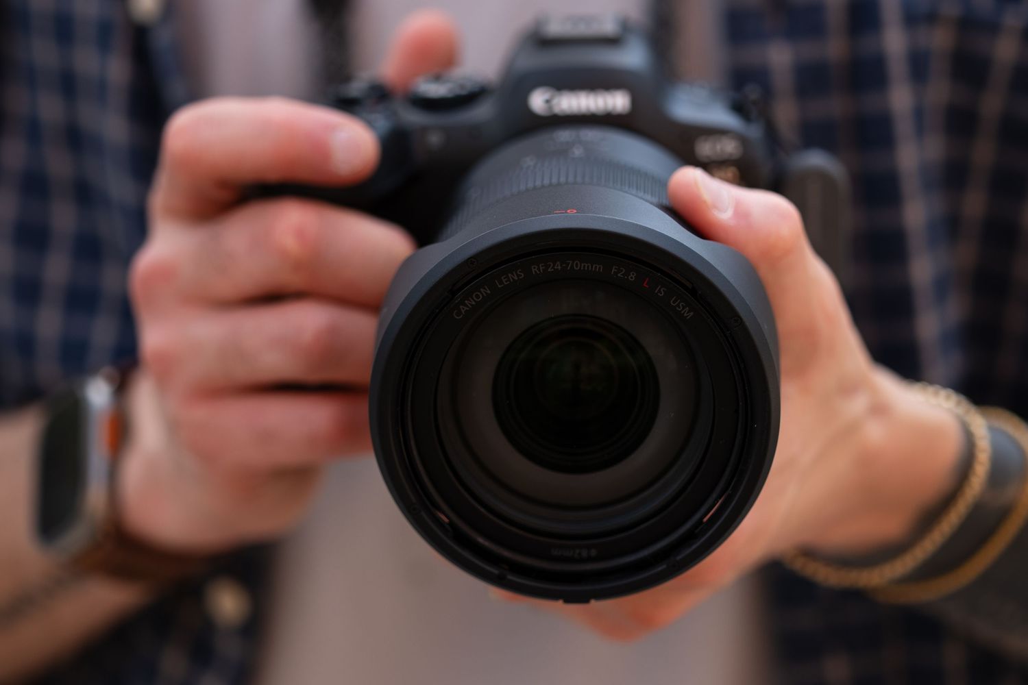 Multiple angles of hands holding and operating a Canon DSLR camera.