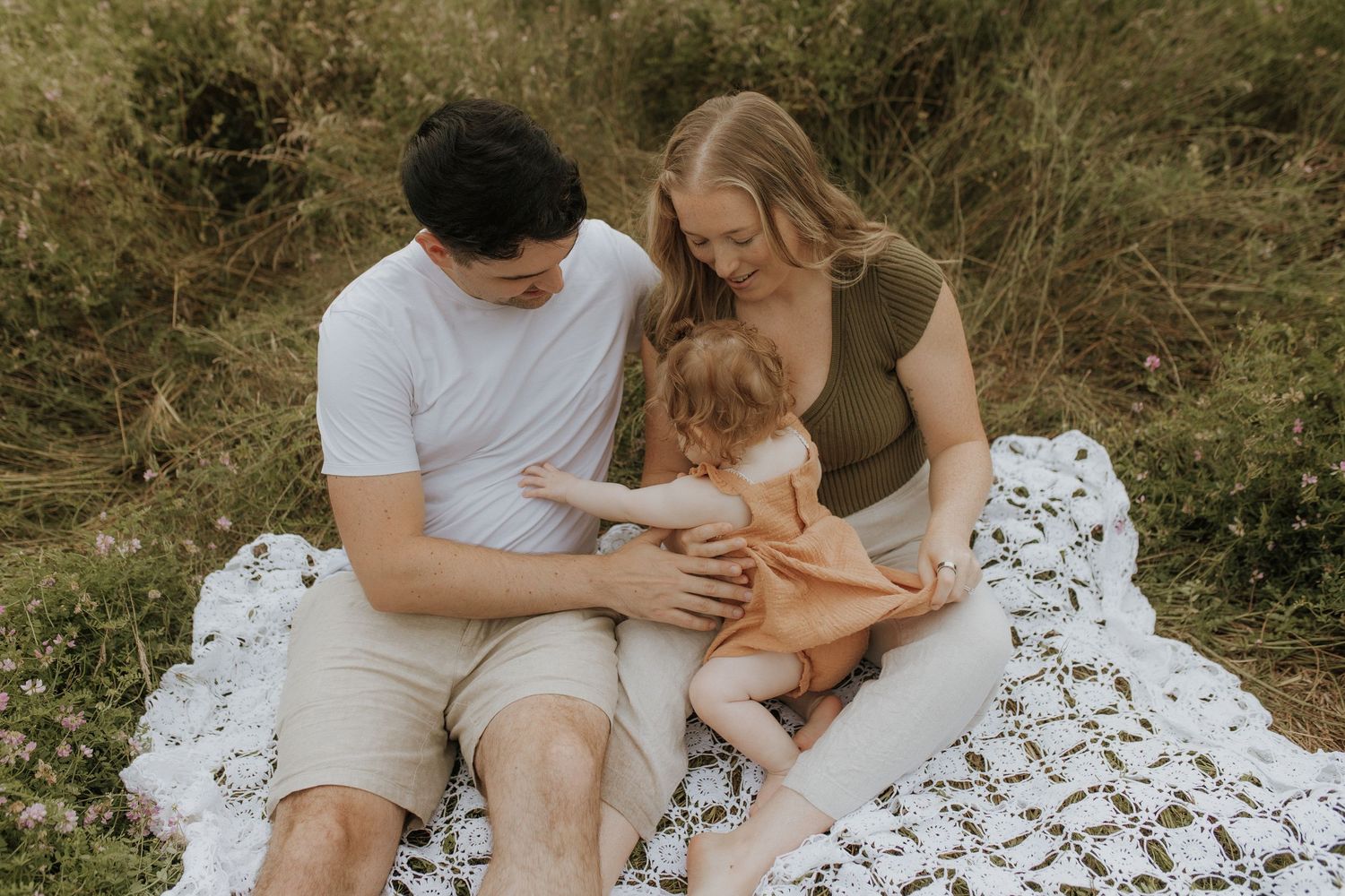 Parents sharing a candid moment during a family session by Bowmanville family photographer