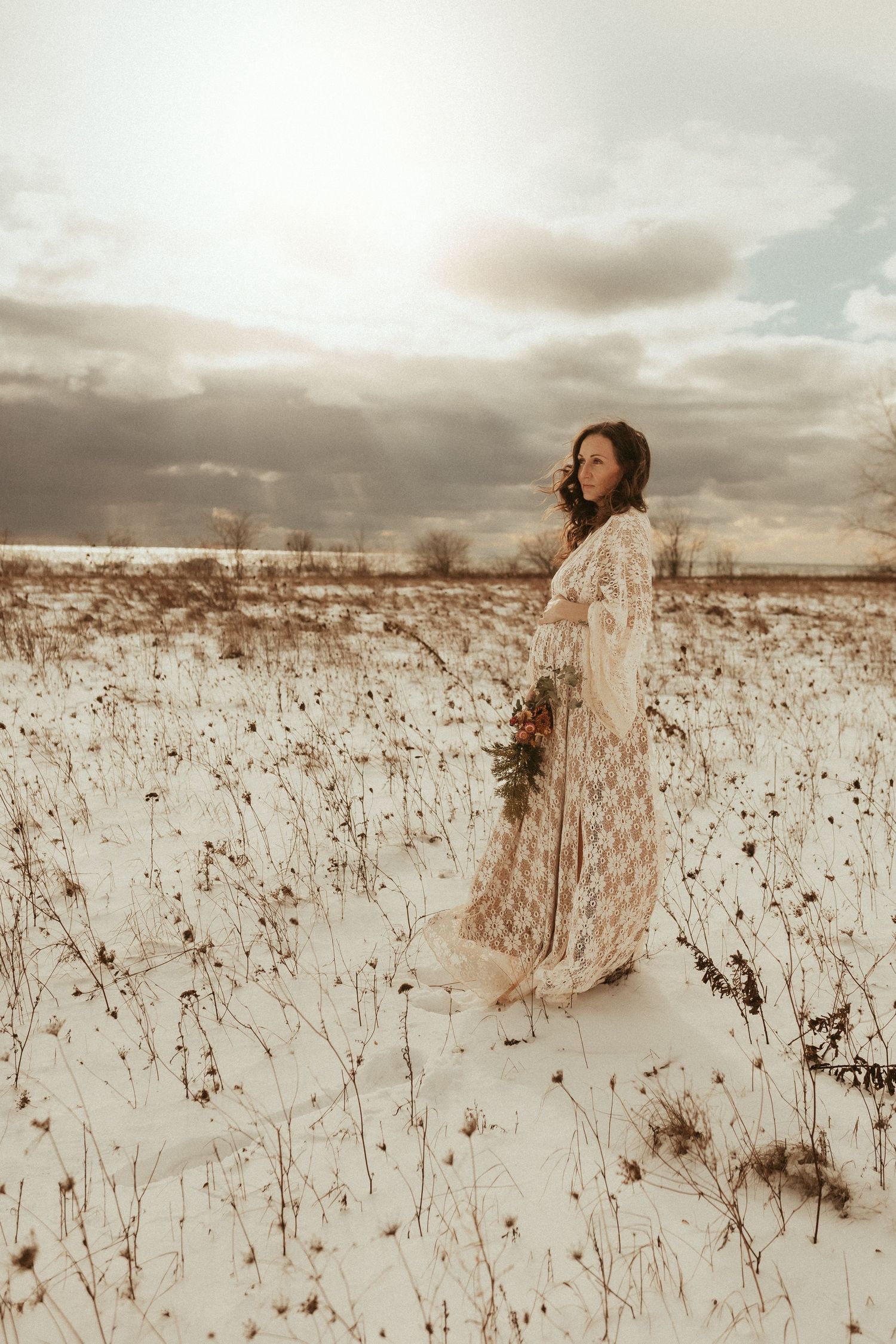 maternity session on a winter beach with lace gown and sweet baby bump by maternity Bowmanville, ON photographer