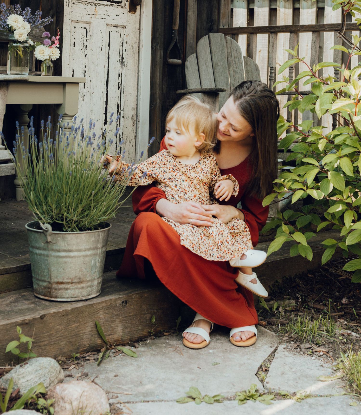 A series of tender moments shared on rustic wooden steps with potted plants and vintage decor in the background.