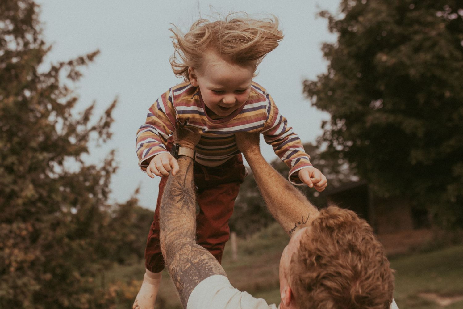 Father playing with his son by Durham region motherhood photographer