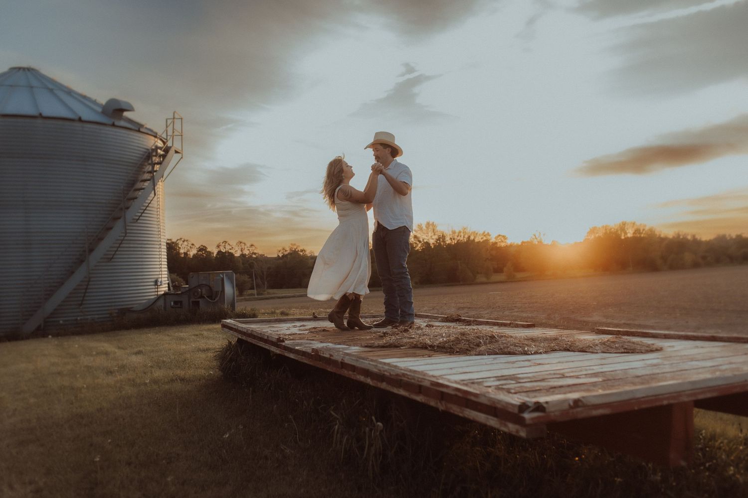 Engaged couple dancing at sunset during outdoor session in Orono Ontario by local family photographer