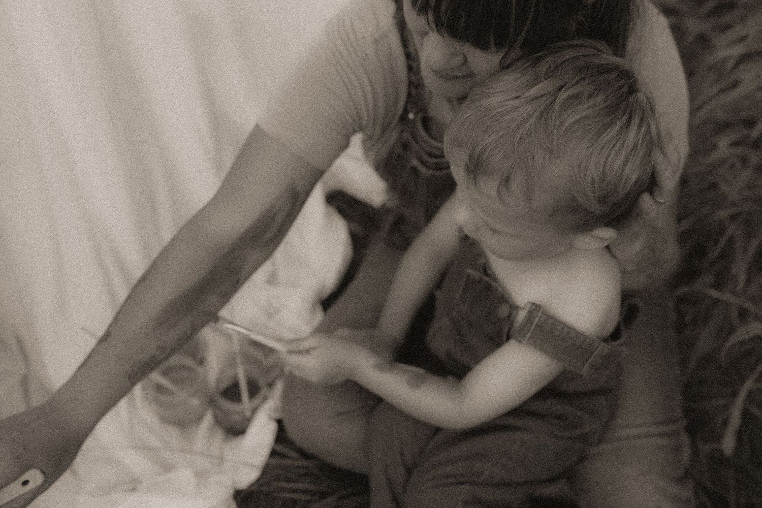 An artsy black and white shot of a mom and son painting together by Courtice family photographer
