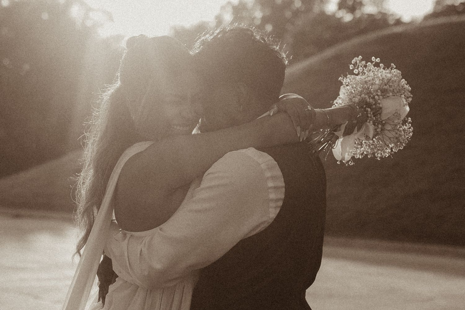 A bride and groom sharing an intimate embrace during golden hour by natural wedding photographer Bowmanville