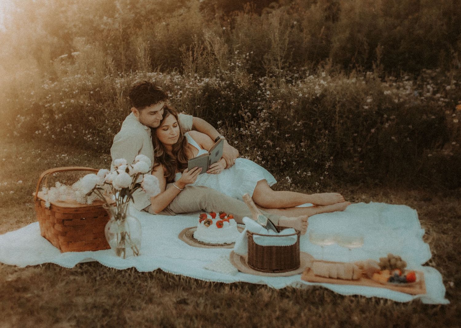 A newly eloped couple sharing a picnic during golden hour at the beach by Cobourg Elopement Photographer
