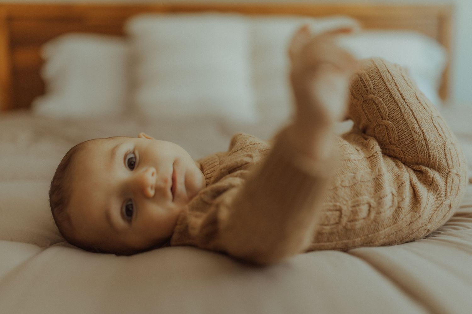 Newborn baby looking at the camera as he lies on the bed for Bowmanville, ON family photographer