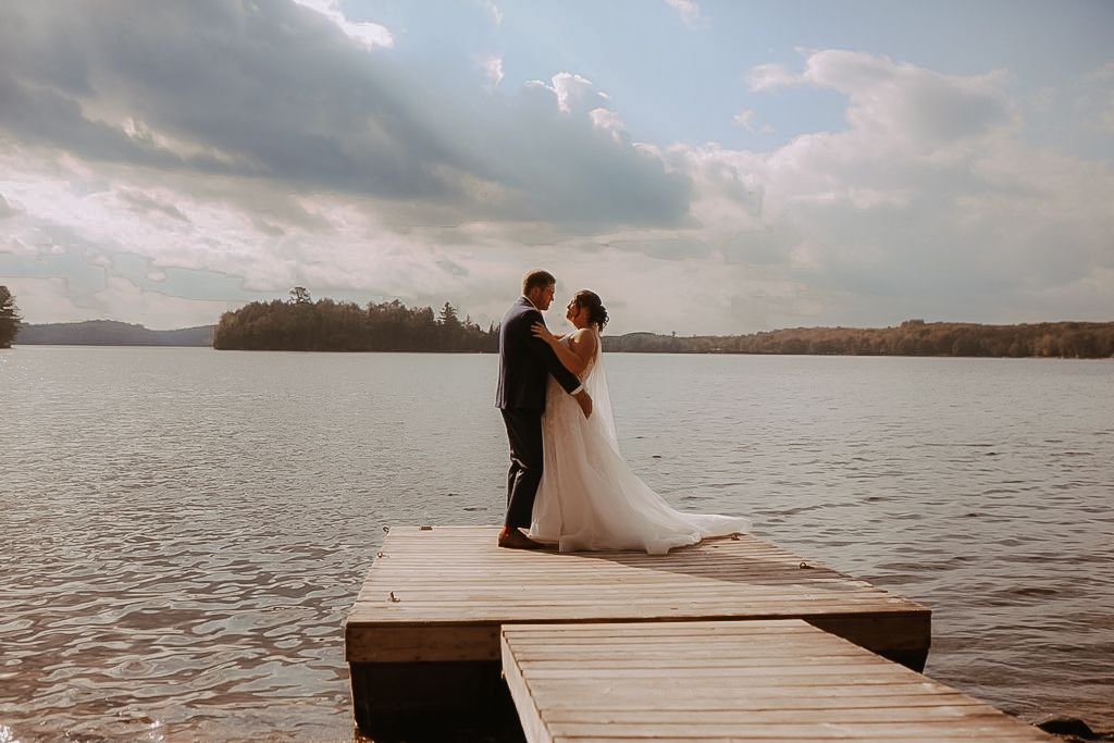 Image of a couple dancing after their intimate wedding on a dock on a lake by natural wedding photographer Bowmanville