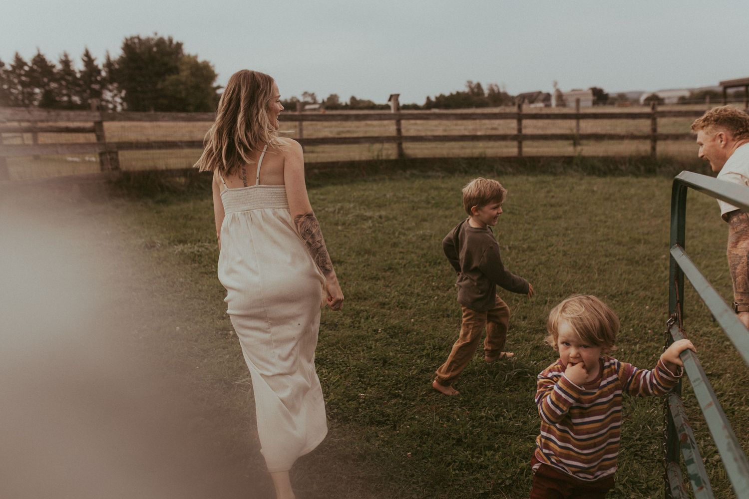 Family playing tag together in yard during a family lifestyle session in Durham Region, Ontario