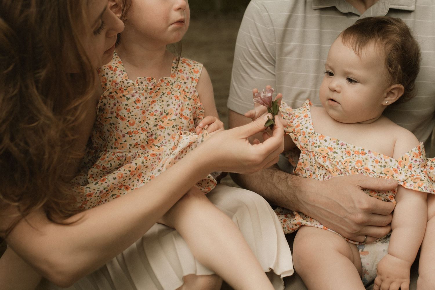 Family embracing and sharing a candid moment during a family photography session in Durham Region, Ontario