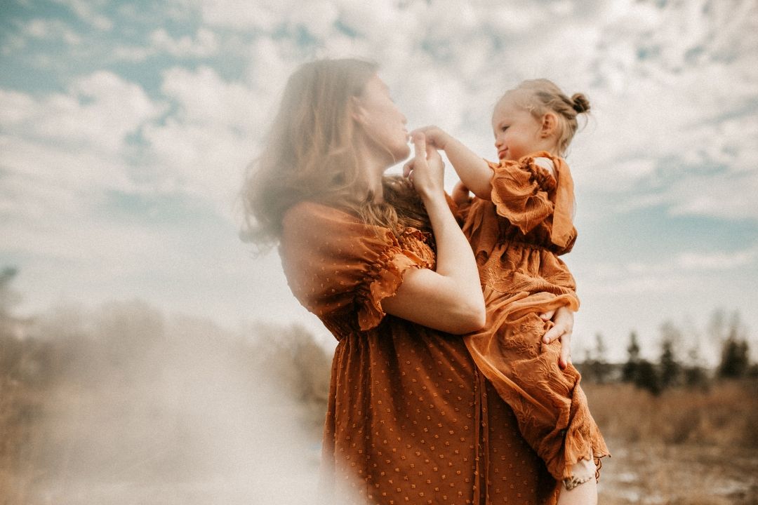 Motherhood outdoor session cradling her sweet baby in flowy dress taken by a Bowmanville, ON family photographer.