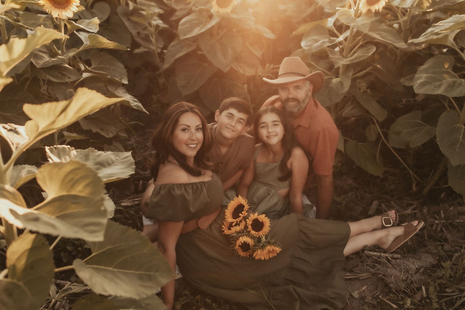 A close-up image of a family looking at the camera during golden hour by Durham Region family photographer
