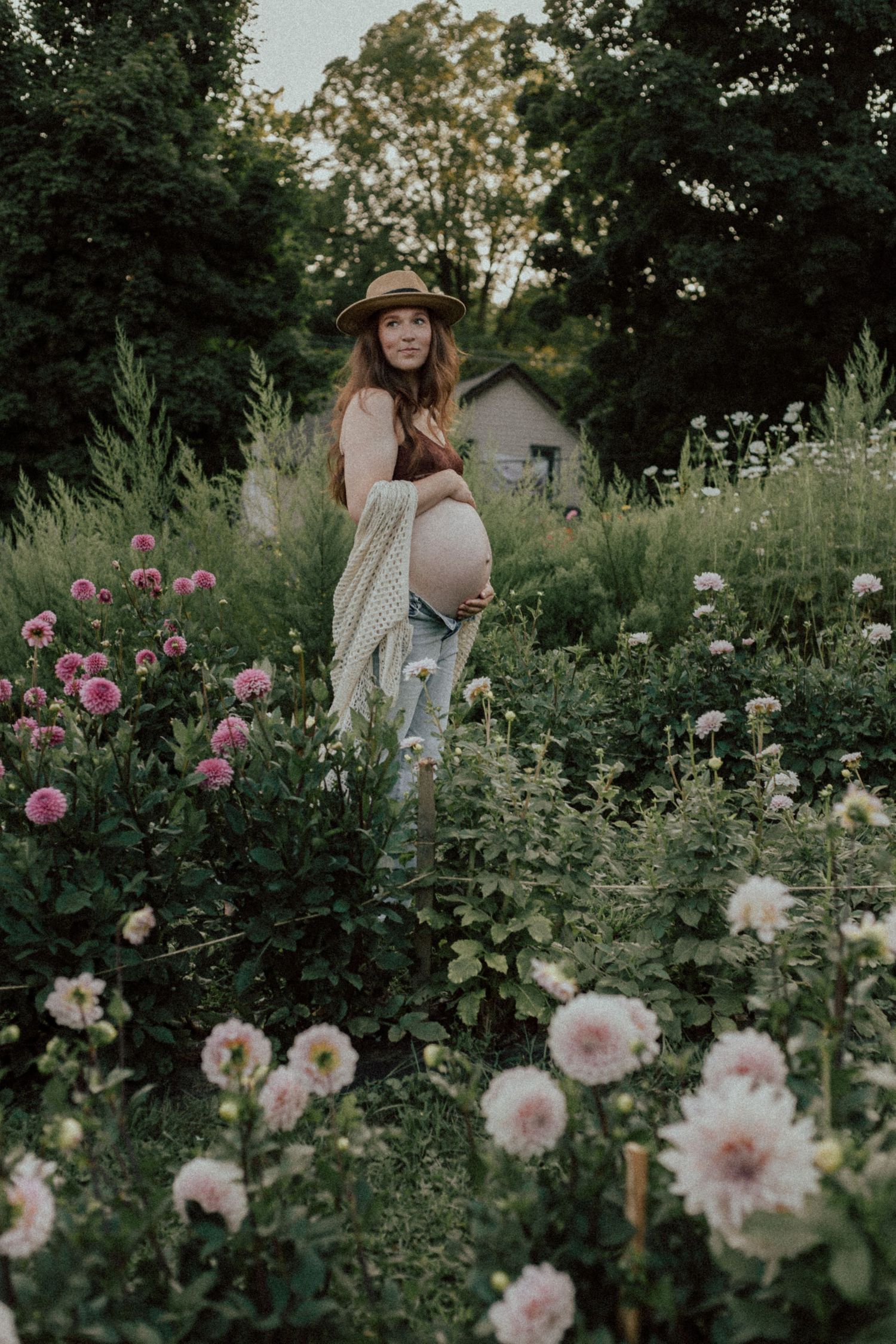 Expecting mother embracing her baby bump during a maternity photography session by Bowmanville family photographer