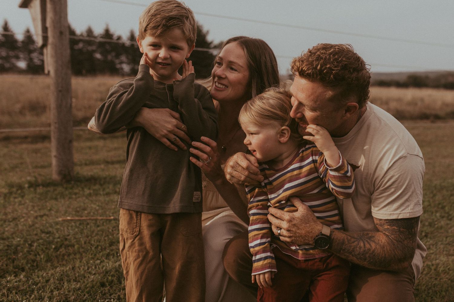 Family enjoying a fun moment outside by Durham region motherhood photographer