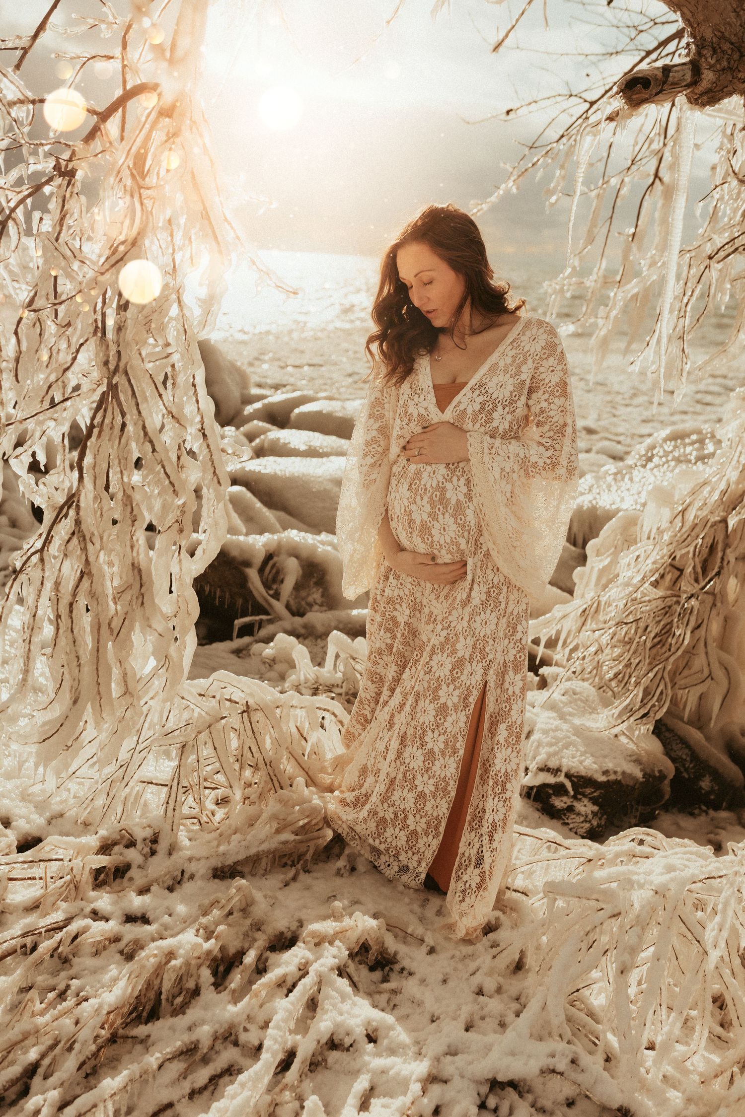Beach maternity portrait with vintage-inspired lace dress in warm, muted tones taken by Bowmanville, ON family photographer.