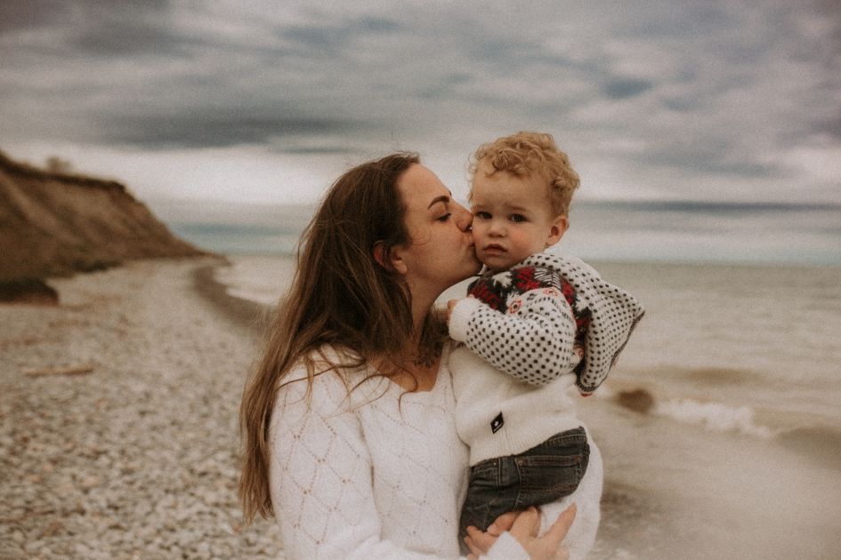 Mom holding her sweet child during a beach family session in Courtice, ON.
