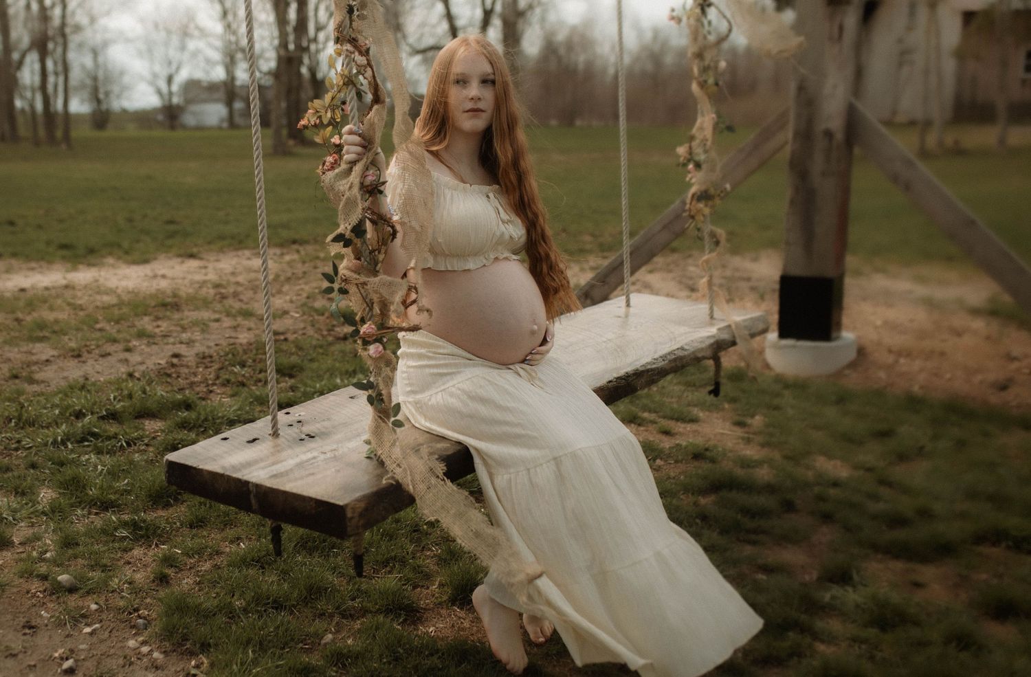 Bowmanville Photography maternity session with a mom on a swing in spring time.