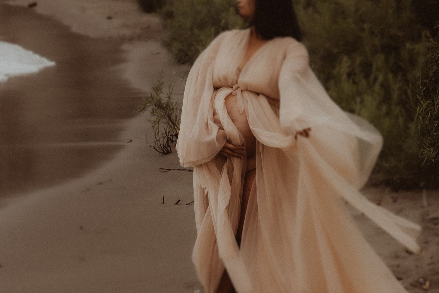 Moody photo of a mom in a long dress by Durham Region maternity photographer