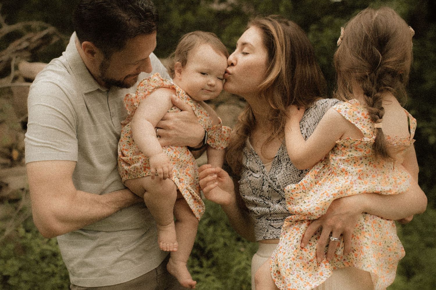 A photo of a family kissing and holding each other by Durham Region maternity photographer