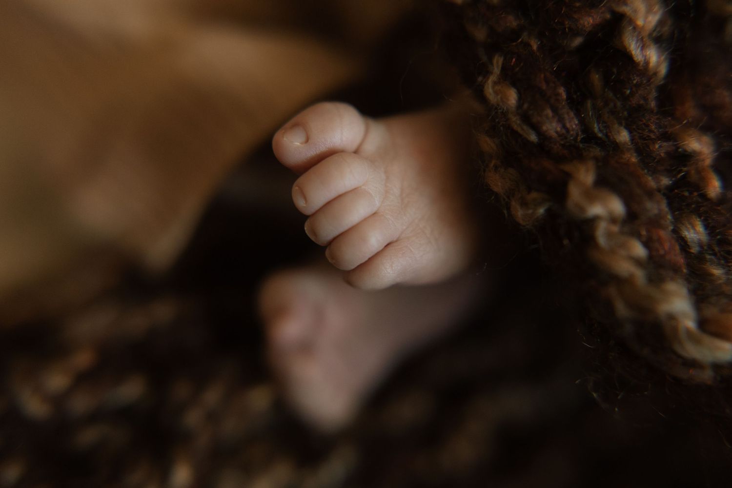 Newborn baby's tiny feet during a lifestyle newborn photography session in Durham Region, Ontario