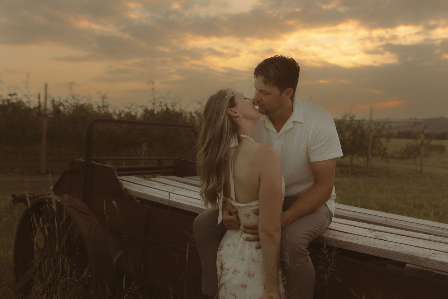 Couple sharing a quiet moment at sunset during a maternity photography session in Durham Region, Ontario