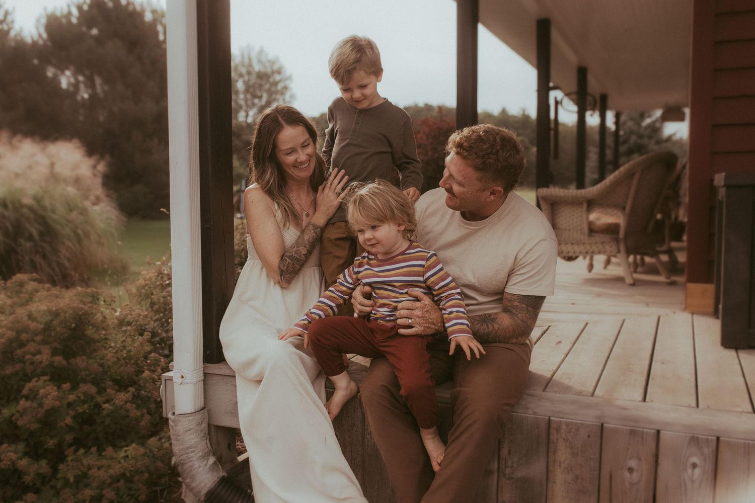 Family sitting on the front porch together during family lifestyle session in Durham Region, Ontario