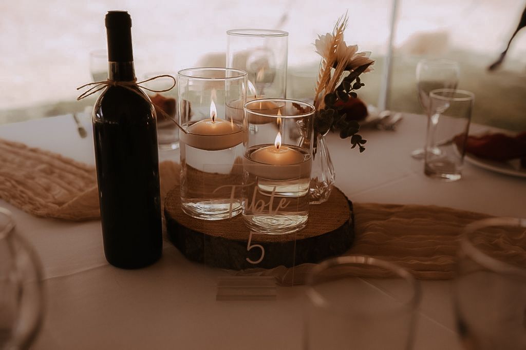 Tablescape photo of candles, fall flowers, wine, and plates by Durham Region wedding photographer