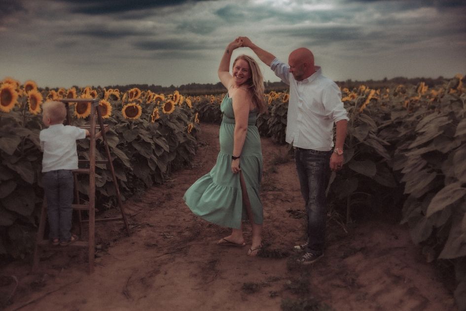 A family dancing in the sunflower fields in Durham Region.