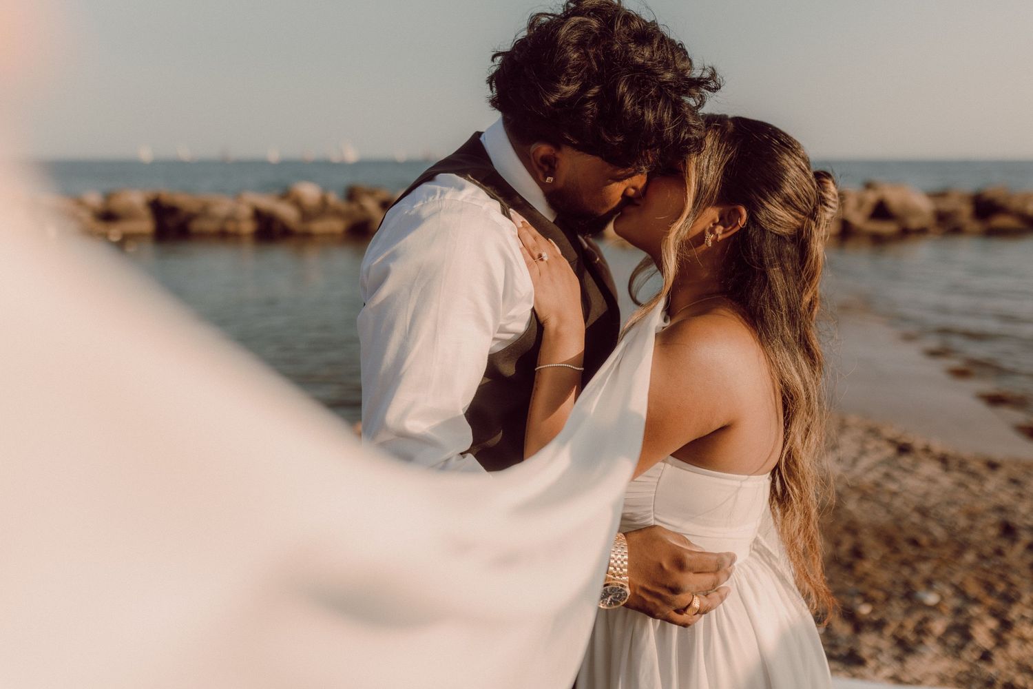 Bride and groom kissing on a Toronto beach by natural wedding photographer Bowmanville