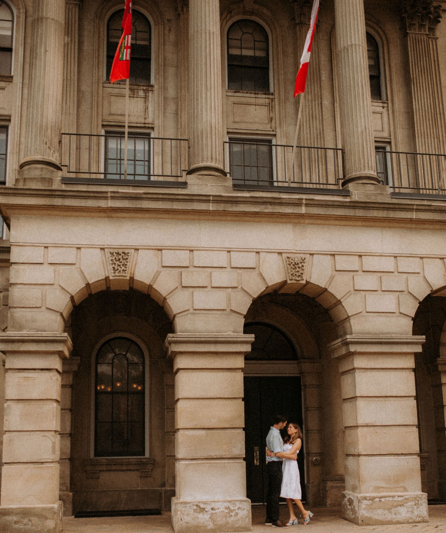 A couple dances beneath the columns of grand Victoria Hall after their wedding by Cobourg Elopement Photographer