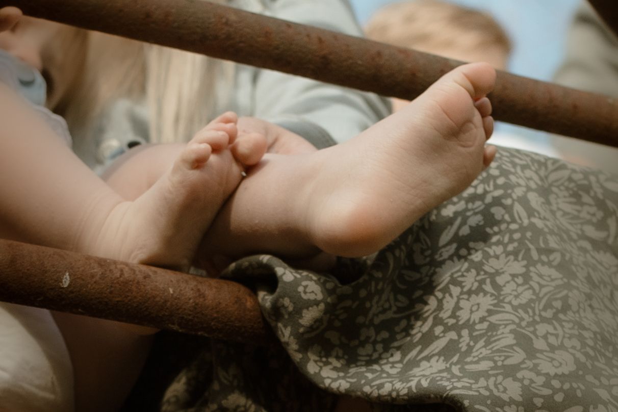 Child's little feet during a candid family photography session in Durham Region, Ontario