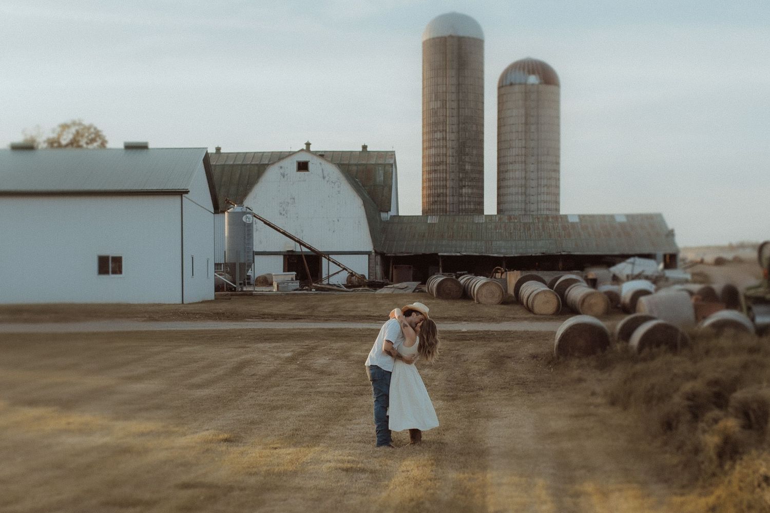 Engagement couple walking in sheep farm at sunset in Orono Ontario photographed by family photographer
