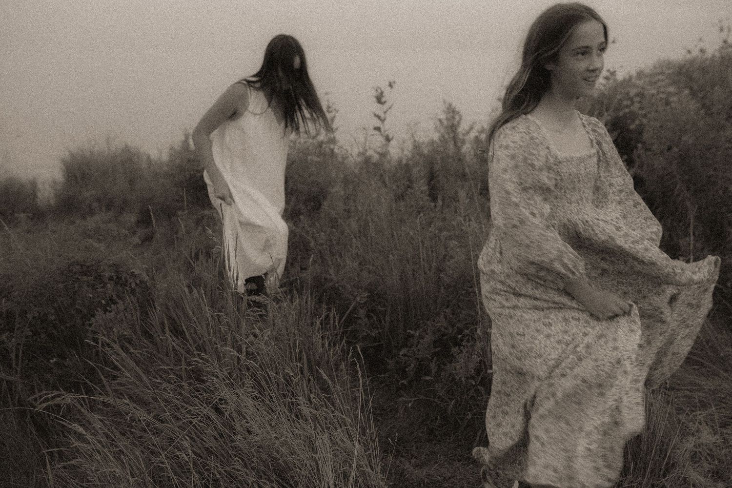 Artsy image of  two girls running in a field in Durham Region, Ontario